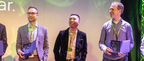 Group of men receiving awards onstage