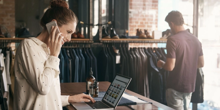 A young woman in front of her clothing boutique