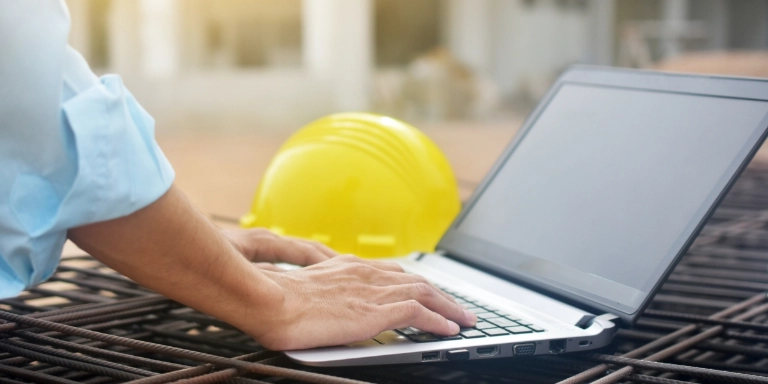 Business person with notebook and helmet on a construction site